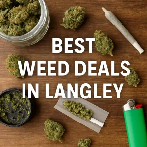 Cannabis buds, grinder, joint, and lighter laid out on a wooden table.